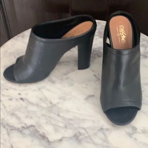 Black faux leather mules